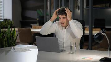 Shocked Caucasian businessman with laptop failure in office business man shock problem fail lose online trouble company crisis male professional computer stress worker bankrupt browsing pc crash error photo