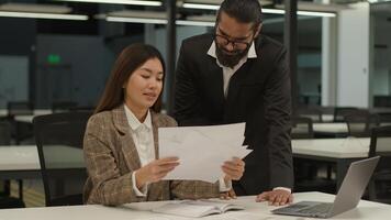 Divers business partners company workers multiethnic colleagues Indian man leader Arabian businessman talk Asian woman employer help Korean businesswoman discuss papers documents paperwork in office photo