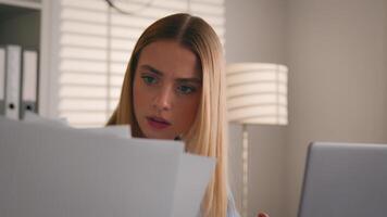 Woman girl business accountant businesswoman using laptop at home office confused dissatisfied with documents mistake check data in papers and computer doing accounting work financial problem annoyed photo