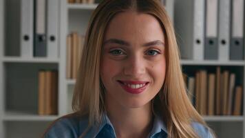 Close up moving shot business portrait Caucasian smiling woman in office smile toothy looking at camera happy businesswoman cheerful worker female manager entrepreneur headshot student girl at library photo