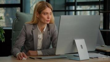 Caucasian 40s woman typing computer online job in office busy with telework internet company working. Businesswoman manager worker using corporate web service executive female chatting with clients photo