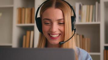 Caucasian woman business girl distant student internet teacher call conference class lesson e-learning virtual meeting nod head yes positive answer listen music headphones with laptop in office photo