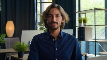 Arabian middle eastern ethnic man businessman programmer software coder office worker executive manager employer entrepreneur working with laptop computer business corporation looking at camera smile photo