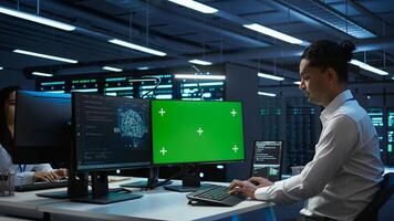 Engineer using AI tech on green screen PC to do checkup in server room. Zoom in of expert in data center using artificial intelligence on mockup computer to process datasets for training, camera B photo