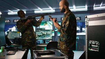 Operatives conducing special operation, loading weapons, preparing to attack enemy forces. Close up of army soldier in command center packing guns for assault mission, camera B photo