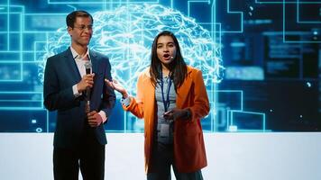 Presenter and specialist guest talking at AI summit bringing together tech startups professionals, exploring latest developments in artificial intelligence and deep learning technology, camera A photo
