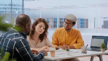 Clients and realtor on an office tour evaluating modern workspace design and discussing investment strategies and leasing options. Reviewing blueprints and planning office relocation. Camera B. photo