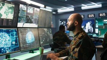 Army specialist employing AI tech to improve military warfare systems and threat monitoring. IT admin uses neural networks to enhance combat operational capabilities, camera B photo