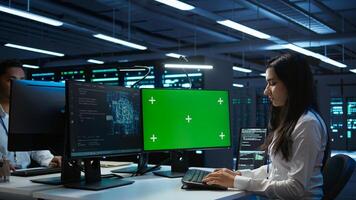 Admin using AI tech on isolated screen PC to do maintenance in server room. Specialist in data center using artificial intelligence on chroma key to process datasets for training, camera B photo