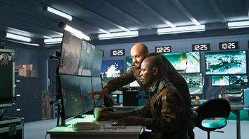 Team of army telecommunications operators using radio and satellite gear, cooperating to provide combat support. Teamworking military dispatchers colleagues managing communications networks, camera B photo