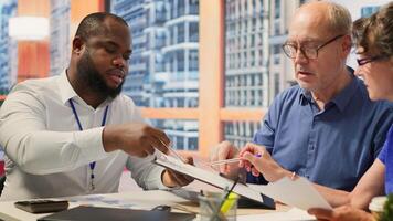Mature couple receiving professional advice on retirement planning, discussing potential comprehensive strategy to secure their savings and investments for the long term. Counseling. Camera A. photo