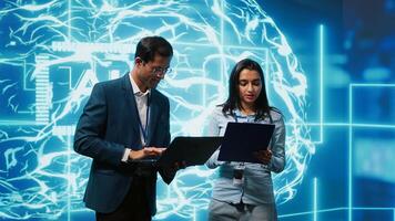 AI researcher and coworker working with artificial intelligence neural networks. Computer scientists collaborating on developing AI system in high tech workspace, camera A photo