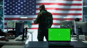 US army working in a top secret control center with isolated mockup screen, ensuring national safety while studying surveillance footage from radar cctv. Command service. Camera B. photo