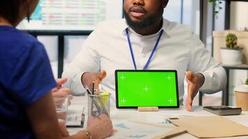 Financial advisor works with a green screen at table with his senior clients, presenting retirement plans and investment options to secure their pension and life savings. Insurance agency. Camera A. photo