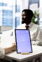 HR specialist using isolated screen tablet to reviewing candidate CV, asking questions about qualifications. Person getting hired by recruiter using mockup device after proving skills for job photo