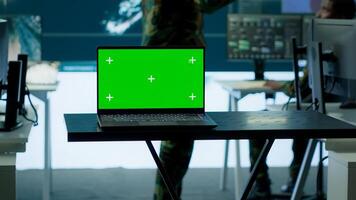 Cybersecurity team operates in an advanced military command center, surveillance systems and data protection. Army personnel work on national security operations using high tech gear. Camera B. photo
