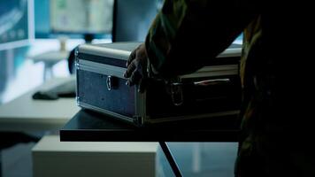 Military personnel operating in a secure office environment, processing critical information and data on big screen. Maintaining protocols essential for national defense and operations. Camera A. photo