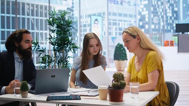 Financial adviser assisting clients in setting up investment accounts, transferring assets and executing financial transactions. Agent utilizing financial planning software to help customers, camera A photo