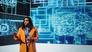 Tech company CEO using conference as platform to present latest AI services. Woman uses microphone to talk at convention with business investors interested in artificial intelligence, camera B photo