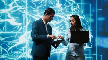 Coworkers using AI neural networks modeled after human brain, brainstorming ways to solve complex problems. IT department staff members using deep learning to look at data and complete tasks, camera A photo