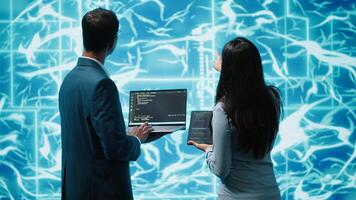 Team of admins using tablet and laptop to maintenance artificial intelligence neural networks. Teamworking IT staff members using AI system aiding in processing and transmitting information, camera A photo