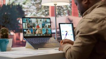 Businessman presents annual sales reports to the shareholders on videocall, working from home to increase funding. Entrepreneur making a development presentation for the investors. Camera A. photo
