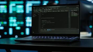 Focus on laptop used by engineers coding in modern data center, monitoring security threats. Close up of notebook used by employee in blurry background ensuring compliance with regulations, camera A photo
