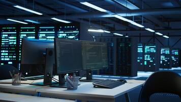 Data center business with networking systems installed used for managing mainframes. Code running on computers in futuristic server room used for overseeing equipment, dolly in shot photo