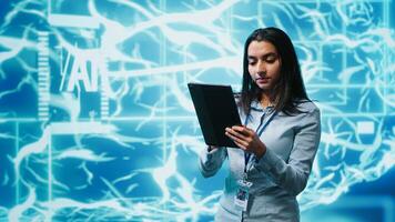 Developer using tablet to implement artificial intelligence parallel processing, breaking up complex computational tasks enabling AI systems to process more input data faster, camera A photo