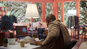Software engineer coding on a laptop focusing on deep learning, database management and binary code to develop next generation AI solutions and interfaces. Database processing. Camera B. photo