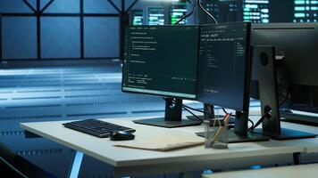 Computers in data center used for monitoring security attacks threatening supercomputers rows. PCs used by futuristic server hub workplace admins to protect equipment, handheld camera shot photo