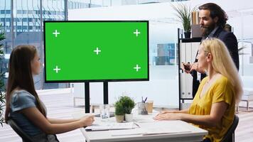 Broker in office offering financial advice to clients, looking at forex index values on green screen display. Financial advisor analyzing customers market shares on chroma key device, camera A photo