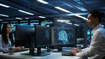 Computer scientist using AI tech on PC to do checkup in server room. IT staff member in data center using artificial intelligence technology to process datasets for training, camera B photo