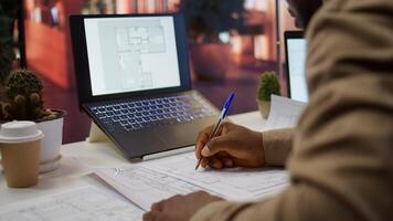 Corporate owner measuring and evaluating office blueprints and architectural sketches, working on strategy planning for a modern and professional workspace design. Relocate office space. Camera B. photo
