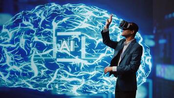 System administrator wearing VR headset looking at hologram of artificial intelligence human brain simulation. IT expert interacting with AI visualization showing deep learning algorithms, camera B photo