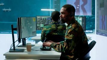 Soldiers in a state of the art military control room collaborate on data analysis, intelligence gathering, and mission planning. Ensure effectiveness and security of military operations. Camera A. photo