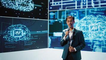 Presenter talking with spectators at AI convention bringing together IT specialists, sharing insights from latest developments in artificial intelligence and cognitive computing, camera B photo