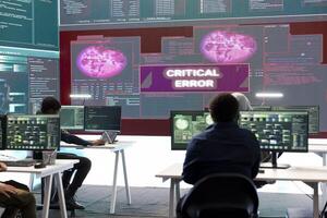 IT specialists receiving error messages on a big screen after trying to hack a government system, failing to steal important information for cyber warfare tactics. Frustrated hackers. photo