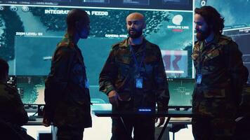 Navy operation specialists monitoring surveillance radar through a hologram, working with 3d illustrations in a military control center. Team of generals gathering intelligence. Camera A. photo