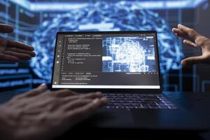 Software developers running AI cognitive computing tech on laptop to simulate computerized model. Close up of notebook used by IT experts in workplace to do data mining with self learning algorithms photo