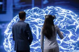 Engineer wearing VR headset and coworker working with artificial intelligence neural networks. Colleagues using virtual reality technology and AI system in high tech workspace photo