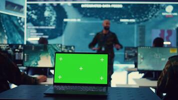 Greenscreen running on a laptop in military base command center, team of army officers monitoring coast line activity to ensure national safety. Soldiers detecting suspicious vessels. Camera B. photo
