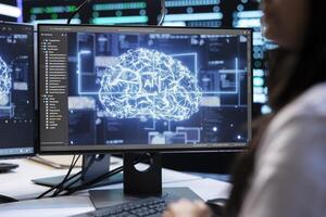 Admin using AI tech on computer to do checkup in server room providing storage. Close up shot of IT specialist using PC to enable artificial intelligence to process datasets for training and inference photo