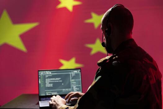 Chinese programmer making bot accounts on social networks promoting communist ideology. Technician working for CCP intelligence agency building algorithms to spread fake news photo