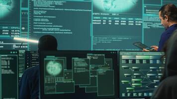 Happy cheerful hackers team gaining access inside network systems, celebrating their achievement and the step forward during hybrid war activities. Pleased experts stealing database info. Camera A. photo