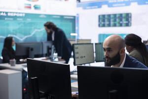 Marketing manager evaluating sales and profit within infographics data, comparing reports on a big screen. Team leader planning promotional activities for a better public image, PR tasks. photo