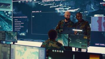 Army officers providing details for a new national safety mission, diverse team briefing their soldiers in a military base of operations. Specialists working with reconnaissance big data. Camera B. photo