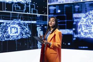 Speaker does presentation during tech corporate event, exploring successful implementation of AI in driving forward startup businesses, sharing latest machine learning discoveries photo