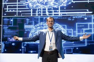 Portrait of smiling IT expert talking in mic at technology summit, explaining impact of AI technology on world. Cheerful tech company businessman presenting risks and threats associated with AI photo