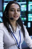 Upbeat supervisor in data center providing support for customers, troubleshooting malfunctions. Portrait of cheerful employee in server room carrying out operational interventions requested by clients photo